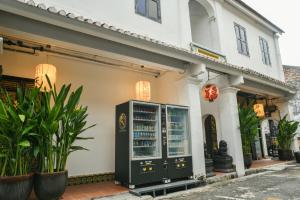 a building with a drink cabinet in front of it at Ohana House @ 31 Jawa in Melaka