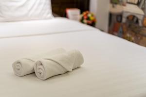 Postel nebo postele na pokoji v ubytování Lotus Laverne Hotel
