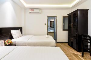Postel nebo postele na pokoji v ubytování Lotus Laverne Hotel
