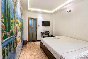 Postel nebo postele na pokoji v ubytování Lotus Laverne Hotel