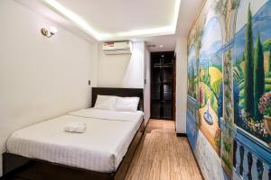 Postel nebo postele na pokoji v ubytování Lotus Laverne Hotel
