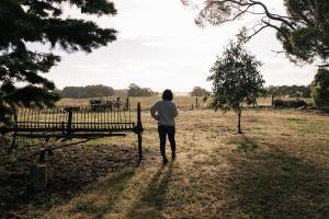 a person walking down a path near a bench at Grampians Historic Tobacco Kiln in Moutajup