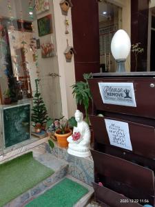 a store front with a christmas tree and a statue at Rudram Hotel Yoga & Ayurveda Retreat in Rishīkesh