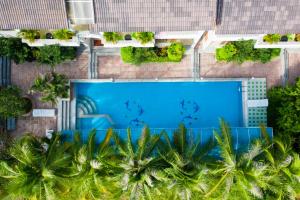 an overhead view of a swimming pool with palm trees at Quynh Mai Resort in Phú Quốc