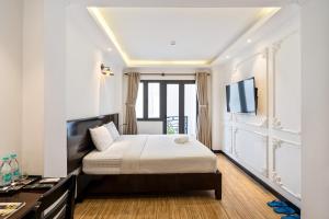 Postel nebo postele na pokoji v ubytování Lotus Laverne Hotel