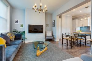 a living room with a couch and a table at City Retreat Hobart in Hobart