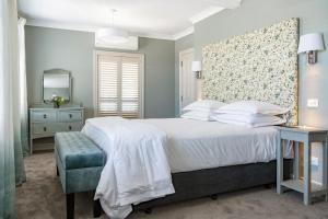 a bedroom with a large bed and a mirror at 415 Marine Parade in Napier