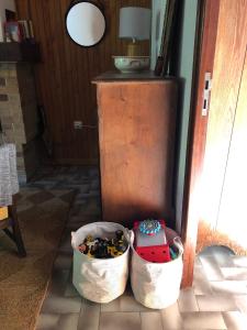 two buckets filled with toys sitting on a floor at Pont de Frappe in Chabottes