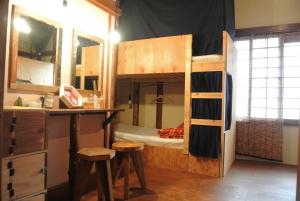 a bedroom with a bunk bed with a desk and stool at Guest House FUTARENO in Yokohama +59 photos