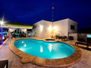 a swimming pool in the middle of a patio at night at Parque España Residence Hotel in Manila