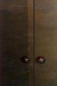 a brown cabinet with two knobs on it at Bob W Ticinese in Milan