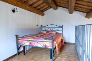 a bed in a room with a wooden ceiling at Bright apartment in Castelbellino - 75 m² - Shared Pool in Castelbellino