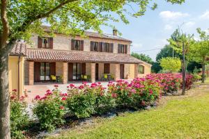 an exterior view of a house with pink flowers at Bright apartment in Castelbellino - 75 m² - Shared Pool in Castelbellino