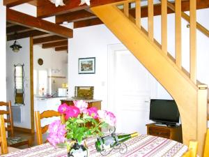 a dining room table with a vase of flowers on it at Maison de 3 chambres avec jardin clos et wifi a Stotzheim in Stotzheim