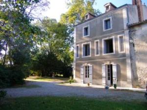 a large white house with trees in front of it at Manoir enchanteur à Cailhau avec piscine privée sécurisée in Cailhau