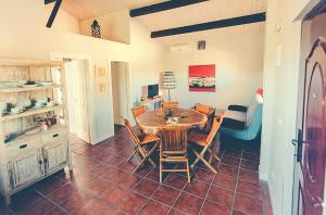 a kitchen and dining room with a table and chairs at 2 bedrooms house with shared pool furnished garden and wifi at Canamero in Cañamero