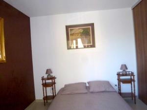 een slaapkamer met een bed en 2 bijzettafels bij Appartement de 2 chambres avec piscine partagee terrasse et wifi a Porto Vecchio a 3 km de la plage in Porto-Vecchio