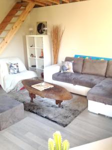 a living room with a couch and a coffee table at Maison de 2 chambres avec vue sur la ville jardin clos et wifi a Dainville in Dainville