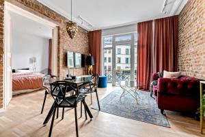 a living room with a red couch and a table at BJØRVIKA APARTMENTS - Solli in Oslo