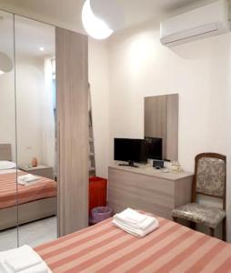 a room with a bedroom with a bed and a mirror at Modern Apartment in the Heart of Rome, 42 m², Parking Included in Rome