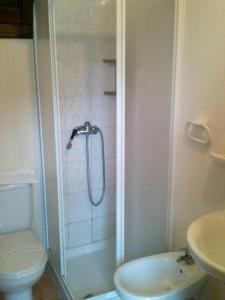 a bathroom with a shower with a toilet and a sink at 2 bedrooms appartement at Mongiove 200 m away from the beach with furnished terrace and wifi in Mongiove