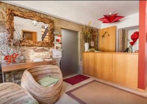 a living room with a mirror and a chair at Luxurious House in Braga with Pool in Barreiros