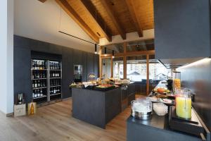 a kitchen with a counter with food and drinks at Chalet Blanc in Breuil-Cervinia