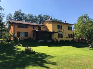 a large house with a large yard in front of it at 2 bedrooms chalet with furnished terrace at Giarola in Busana