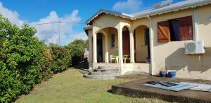 Casa blanca pequeña con porche y escaleras en Villa de 3 chambres avec piscine privee et jardin clos a Le moule a 6 km de la plage, en Le Moule