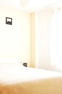 a bedroom with a white bed and a window at Cozy apartment in Dénia, 40 m² with shared pool in Denia