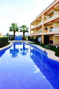 a large swimming pool in front of a building at Cozy apartment in Dénia, 40 m² with shared pool in Denia
