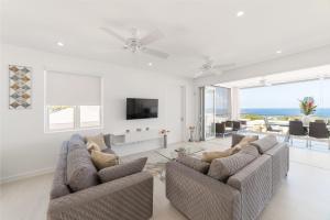 a living room with two couches and a television at Westmoreland Hills - Mount Standfast - St James - Full Gym Membership in Saint James