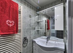 a bathroom with a sink and a red towel at Appartement cosy aux Carroz, 40 m², vue sur la montagne in Les Carroz d'Araches