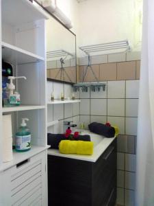 a kitchen with a counter with a yellow towel at Maison de 2 chambres avec vue sur la mer jardin amenage et wifi a Le Francois a 8 km de la plage in Le François