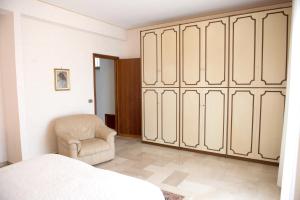 a bedroom with a bed and a chair at 2 bedrooms appartement with terrace at Vita in Vita