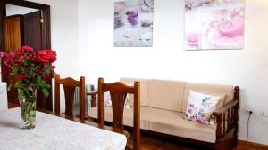 a living room with a couch and a table with a vase of flowers at One bedroom appartement with furnished terrace and wifi at Los Silos 5 km away from the beach in Los Silos