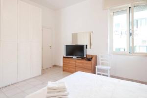 a living room with a tv and a bed at Charming apartment in Vieste with balcony and garden view in Vieste