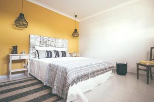 a bedroom with a large bed and a yellow wall at Modern apartment in Estói with shared pool. in Estói