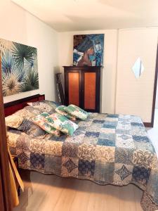 a bedroom with a bed with a quilt on it at Studio paisible à Sainte-Anne avec piscine partagée - 18 m² in Sainte-Anne