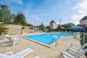 VachersにあるMaison spacieuse à Thenac avec piscine privéeの白い椅子付きの庭のスイミングプール