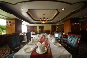 a dining room with a long table and chairs at Welcomhotel by ITC Hotels, Devee Grand Bay, Visakhapatnam in Visakhapatnam