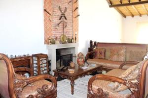 a living room filled with furniture and a fireplace at 7 bedrooms house with private pool enclosed garden and wifi at Corte de Pao E Agua in Corte de Pão e Água
