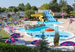 a pool at a water park with a water slide at Bungalow de 3 chambres avec piscine partagee jardin amenage et wifi a Onzain in Onzain