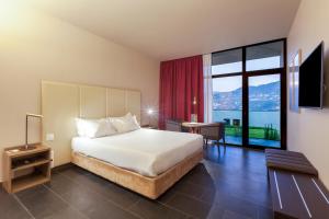 a hotel room with a bed and a large window at Douro Palace Hotel Resort & SPA in Baião