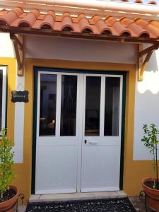 una puerta blanca de una casa con techo rojo en One bedroom house with shared pool furnished terrace and wifi at Santarem, en Santarém