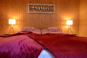 a bedroom with a large bed with two lamps at Alte Post mit Geschichte und Restaurant in Tavanasa