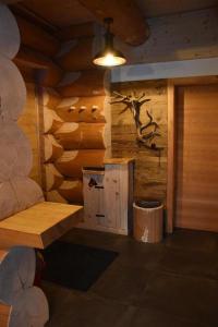 a log cabin with a bench and a deer head on the wall at Chalet-Enzian-Bayerwald in Arnbruck