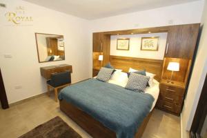 a hotel room with a bed and a mirror at Royal Luxury Apartments & Studios in Amman