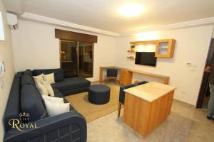 a living room with a couch and a table at Royal Luxury Apartments & Studios in Amman