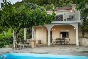 a villa with a swimming pool and a house at Villa Natura prive swimming pool in Lithakia